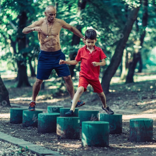 Preview: Grandfather and grandson exercising in park