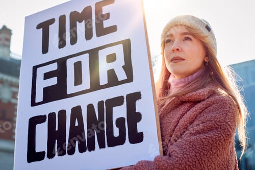 Preview: Female Protestor On Demonstration March Holding Time For Change Placard