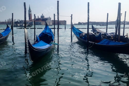 Preview: Venetian boats gondolas in harbor in Venice, Italy