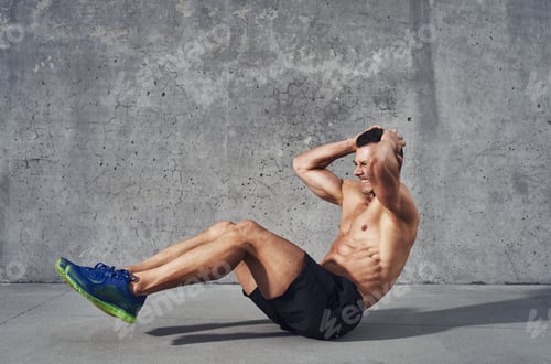 Preview: Fitness model exercising sit ups and crunches