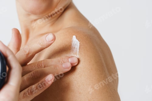 Preview: Cropped photo of mature half-naked woman applying body cream
