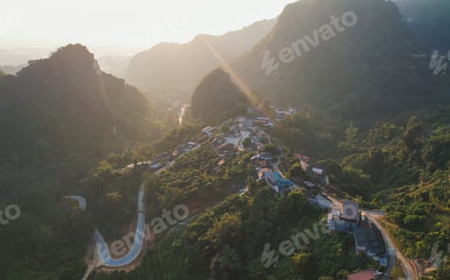 Preview: Aerial view from drone of the rural village in the mountains before sunrise