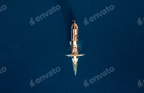 Preview: Beautiful aerial top view of a ship in a calm dark sea
