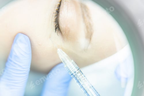 Preview: Woman getting an injection into the under-eye area