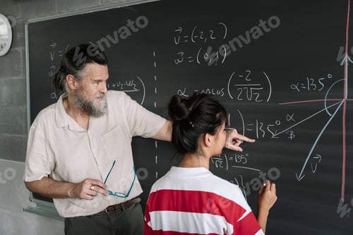 Preview: Young Female Asian Teenager Student doing Maths Exercises on Blackboard