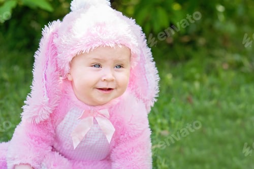 Preview: Children play with real rabbit. Laughing child at Easter egg hunt with pet bunny