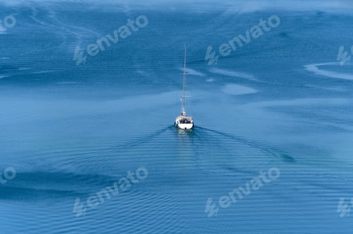 Preview: High angle view of sailing boat on blue sea.
