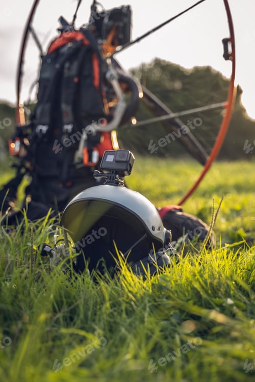 Preview: Close-up of a helmet with an Action Cam mounted on it. In the background the engine to make Powered