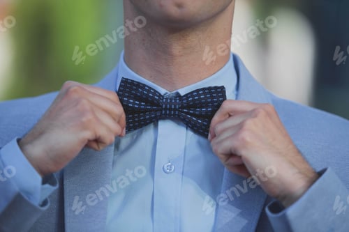 Preview: Man Adjusting Bow Tie Wearing a Jacket