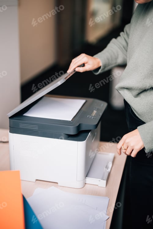 Preview: Female office worker using the printer at the office