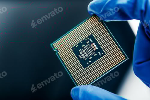 Preview: Semiconductor microchip in gloved hand