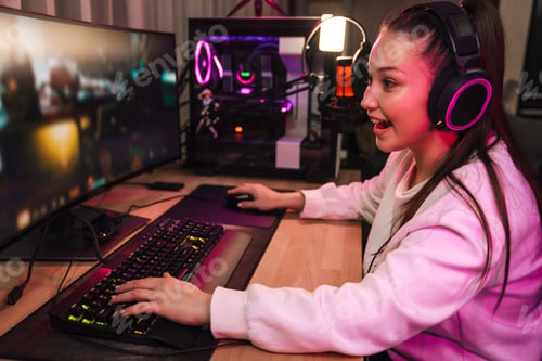 Preview: Happy young woman streamer gamer in headphones