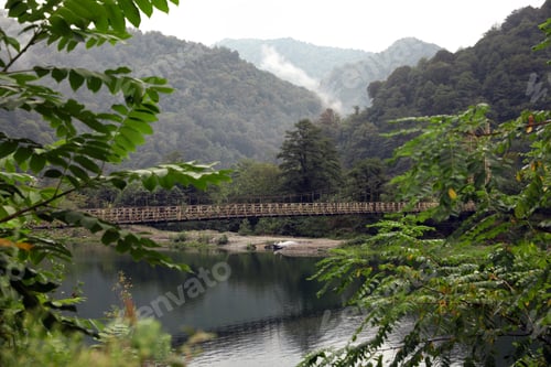 Preview: Beautiful view on rusty metal bridge over river in mountains