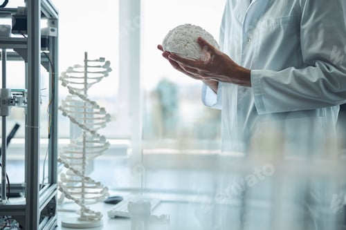 Preview: Man in a white lab coat standing at a desk