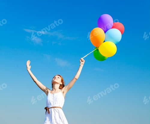 Preview: Redhead girl with colour balloons at blue sky background.