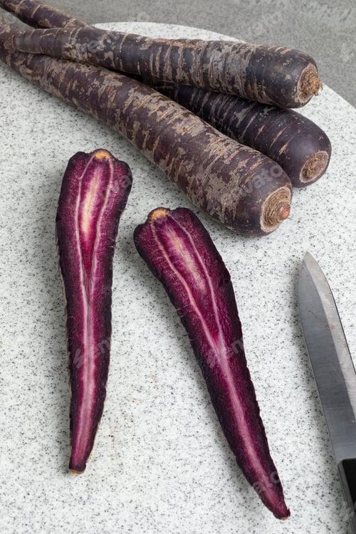 Preview: Purple carrot and slices on a cutting board