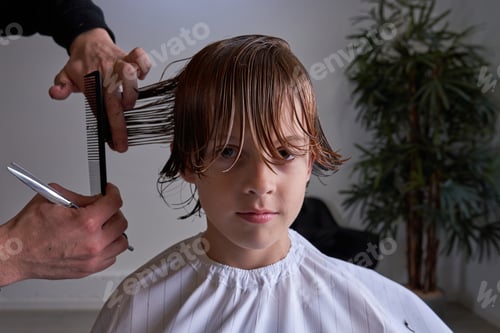 Preview: Boy cutting his hair at a hairdresser's