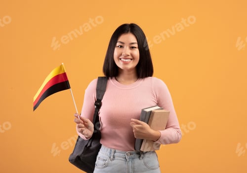 Preview: Teen happy asian woman with backpack holds notebooks and small flag of Germany