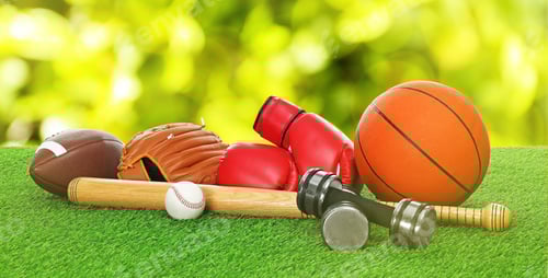 Preview: Different sports equipment on green grass. Banner design