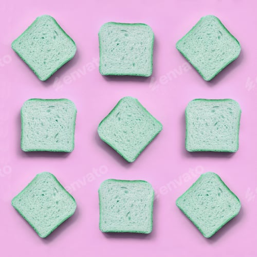 Preview: A few pieces of green bread lies on texture background of fashion pastel pink color paper