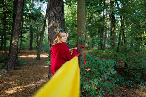 Preview: Woman hooks a hammock to the trees in the forest