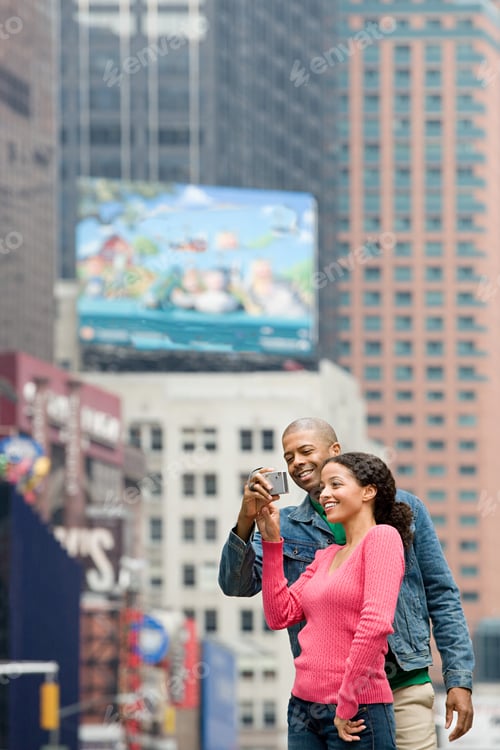 Preview: Couple using digital camera