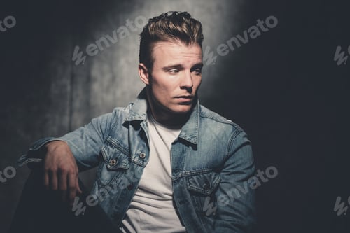 Preview: Retro Fifties Cool Fashion Man Wearing White Shirt And Jeans Jacket. Gray Wall.