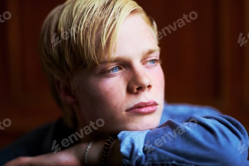 Preview: Wondering what the future holds. Thoughtful and handsome young blonde guy with very blue eyes.
