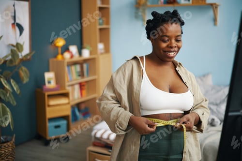 Preview: Measuring Waistline with Tape in Bright Living Room