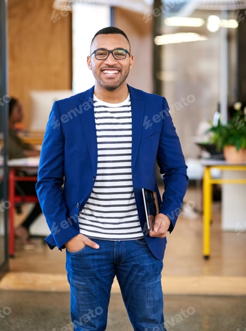 Preview: Shot of a handsome young designer standing in his office