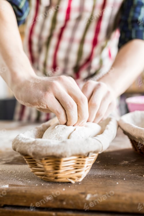 Preview: Midsection of baker with dough in basket