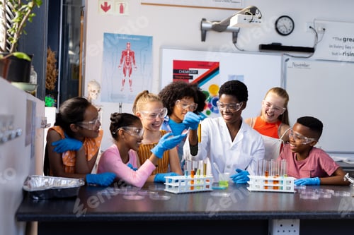 Preview: Happy diverse female teacher and school children doing experiment in chemistry class