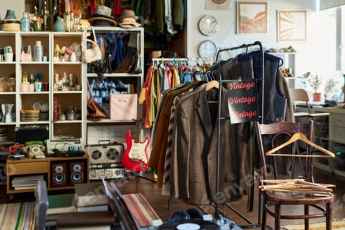 Preview: Vintage Clothing Hanging on Rack Displaying in Thrift Shop Interior Setting