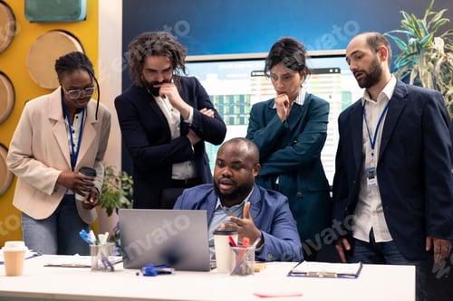 Preview: Diverse business colleagues reviewing project details to ensure objectives