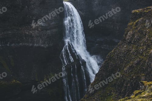 Preview: scenic splashing Haifoss waterfall with mossy cliff on foreground, Iceland
