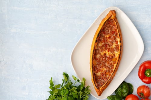 Preview: Turkish baked Pide bread on light blue wooden surface