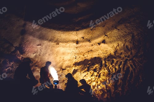Preview: Group of speleologists resting and cooking on gas fire during a cave exploration