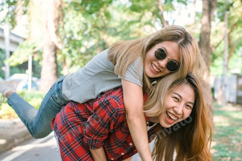 Preview: Happy young asian women couple playing to each other while they do city trip.