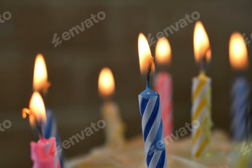 Preview: Lighted lit candles burning on a birthday cake