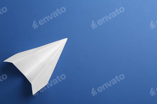 Preview: White paper plane on blue background, top view. Space for text