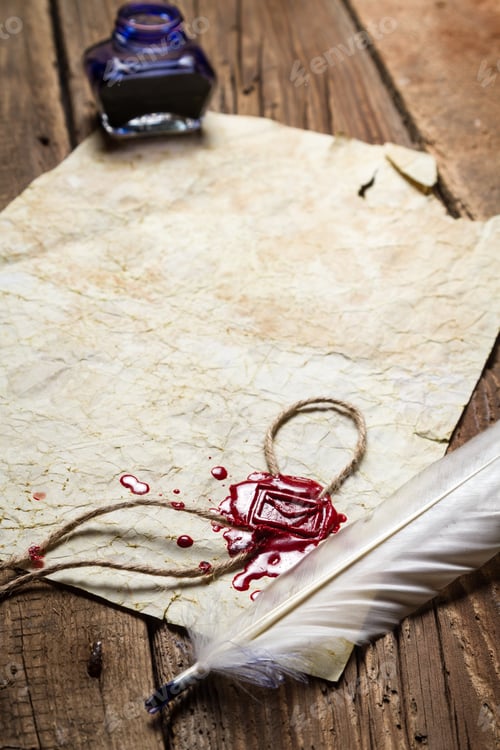 Preview: Closeup of a feather lying on vintage letter with red sealing wax