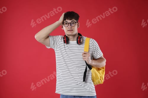 Preview: Student worried about his exam result on red background