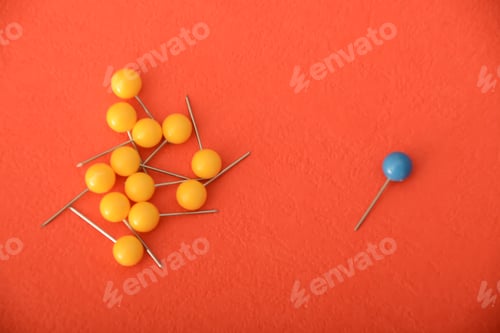 Preview: Among a group of yellow clothespins, the solitary blue one appeared to be abandoned and exceptional.