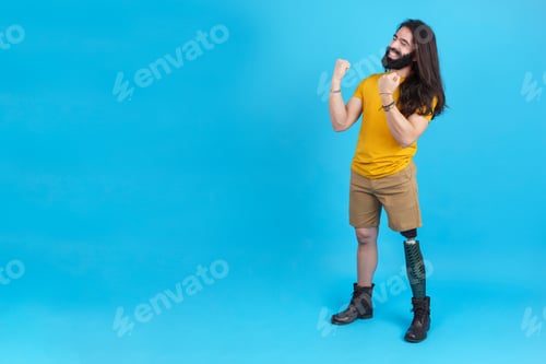 Preview: Man with a leg prosthesis celebrating raising the fists