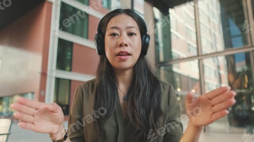 Preview: Young woman freelancer in headphones