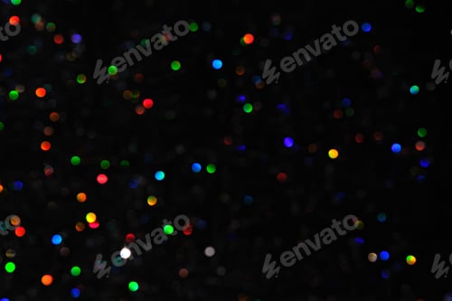 Preview: Abstract black background with bokeh of different colors.