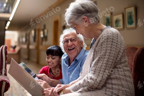 Preview: Nurse teaching seniors in retirement home, how to use laptop