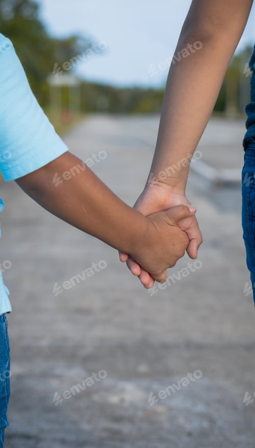 Preview: Latino brothers holding hands on the street