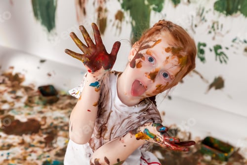 Preview: Portrait of happy young child playing with watercolor