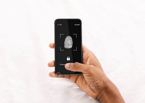 Preview: Black man holding phone with fingerprint scanning app